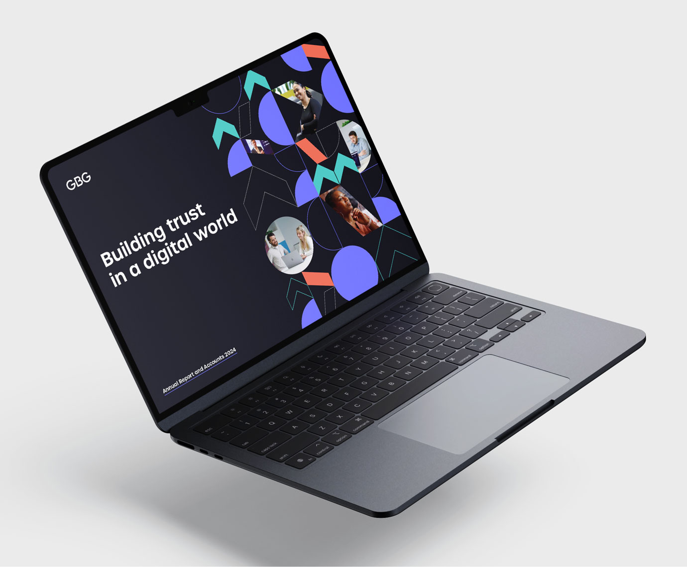 An open laptop showing the cover of an annual report