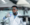 A man in a lab coat works in a high tech laboratory