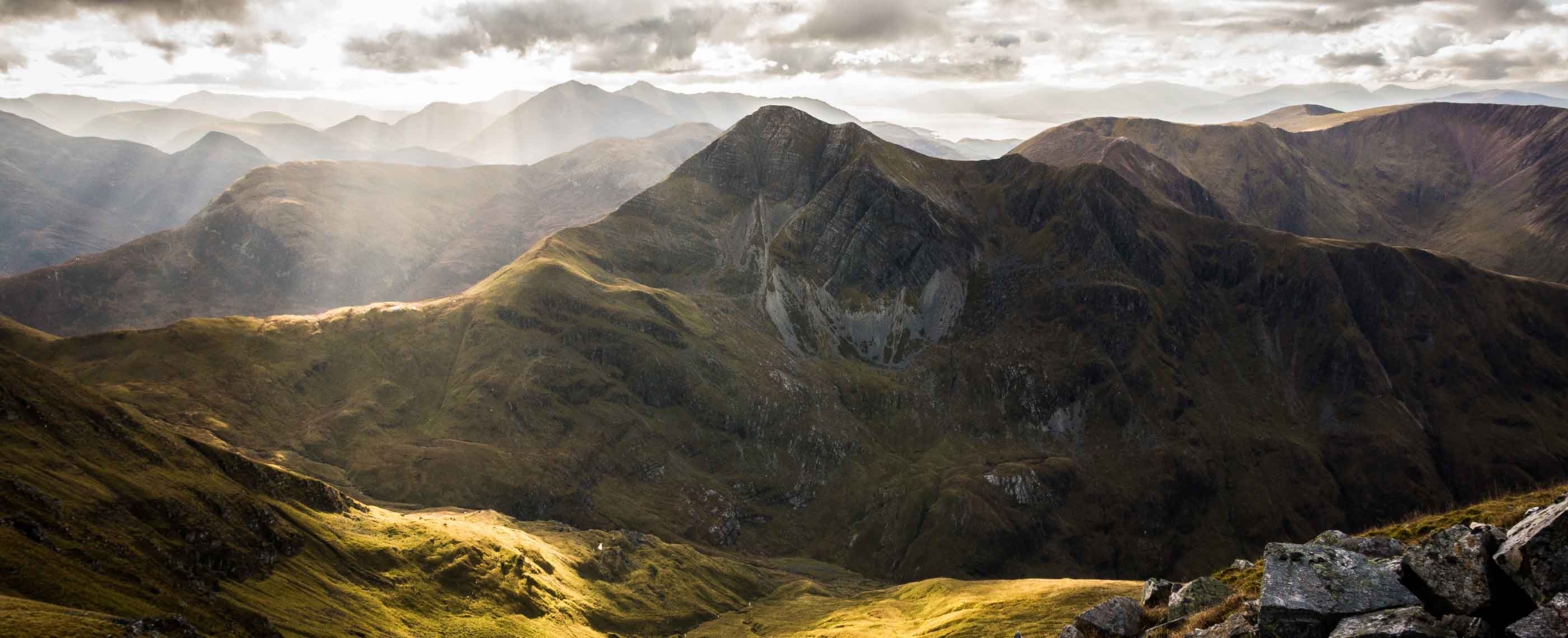 A landscape showing a mountain range in the sunshine
