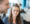 A smiling woman sits with a colleague in an office environment
