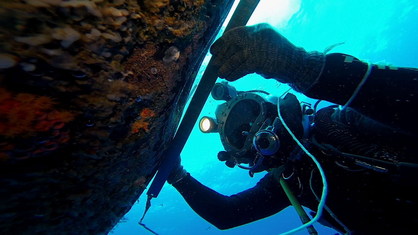 A deep sea diver fixing machinery under water