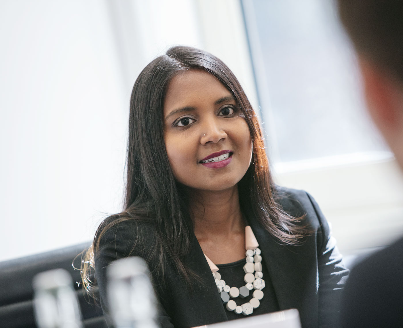 A women working in an office talking to a colleague